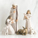 Willow Tree® Set of two faceless woman figurines and one man figurine surrounded by laying donkey and three white sheep figurines