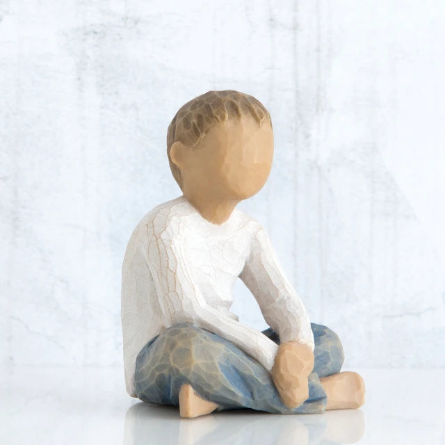 Willow Tree® Small little boy figurine sitting down faceless, wearing white shirt and blue jeans