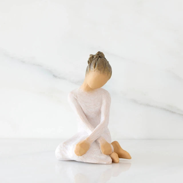 Willow Tree® Front view: seated figure in cream dress with crossed arms
