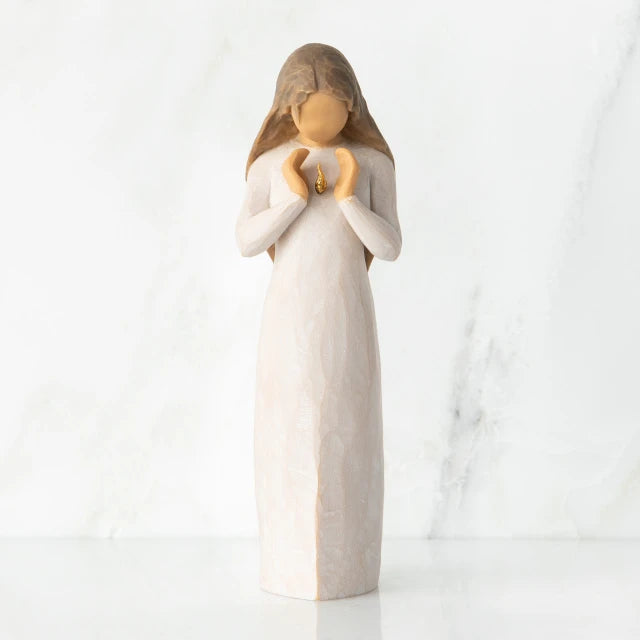 Willow Tree® Front view, standing female figure in cream dress, hands surrounding small gold-leaf flame on chest