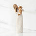 Willow Tree® Front view, standing female figure in cream dress, holding golden color puppy in her arms