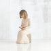 Willow Tree® Young faceless girl figurine in white sitting on rock reading an open book
