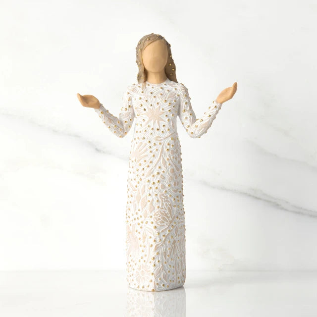 Willow Tree® Front view of brunette girl figurine in white dress with gold dots holding her hands to the side