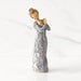 Willow Tree® Front view: Lighter-skin figure carved with contrasting pattern of dark blue musical symbols, instruments, dancing forms