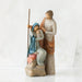 Willow Tree® Nativity scene figurines stanging close, woman in blue is sitting on rock holding baby - man is standing above them holding a stick