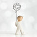 Willow Tree® Front view of little boy with light brown hair holding a wire balloon behind his back. Text on balloon is wire