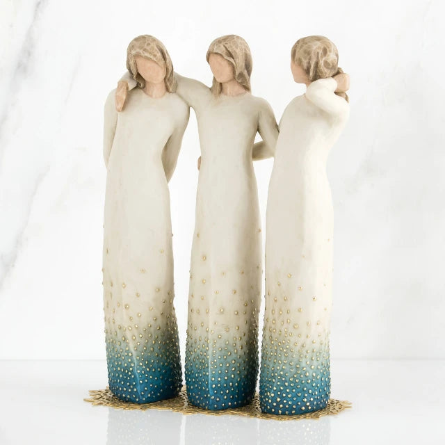 Willow Tree® Set of three standing faceless woman figurines wearing white dresses with blue on the ends of them - they all have their arms around each other