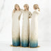 Willow Tree® Set of three standing faceless woman figurines wearing white dresses with blue on the ends of them - they all have their arms around each other